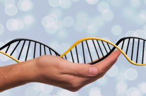 Hand holding a depiction of DNA sequence